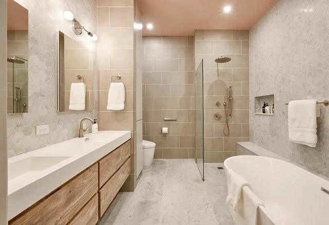  Modern bathroom with tan tiles, wood vanity, and a pink ceiling.