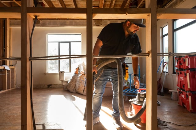 A man cleaning up a construction or renovation site.