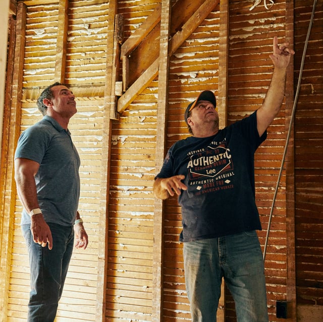 Contractor and homeowner discussing earthquake safety for home renovation and seismic retrofitting