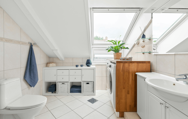 White bathroom with slanted ceiling
