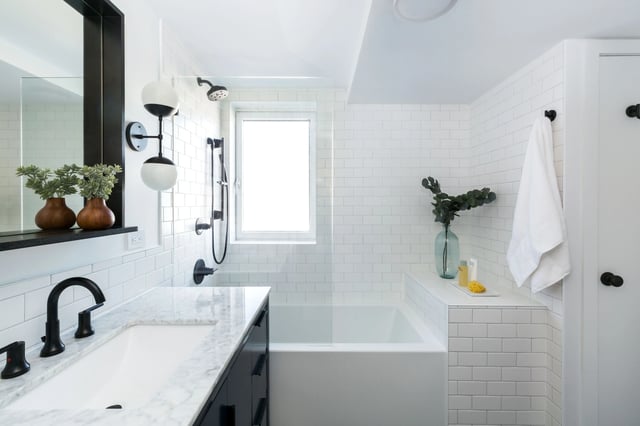 Bright white bath with black fixtures, subway tile, and tub.
