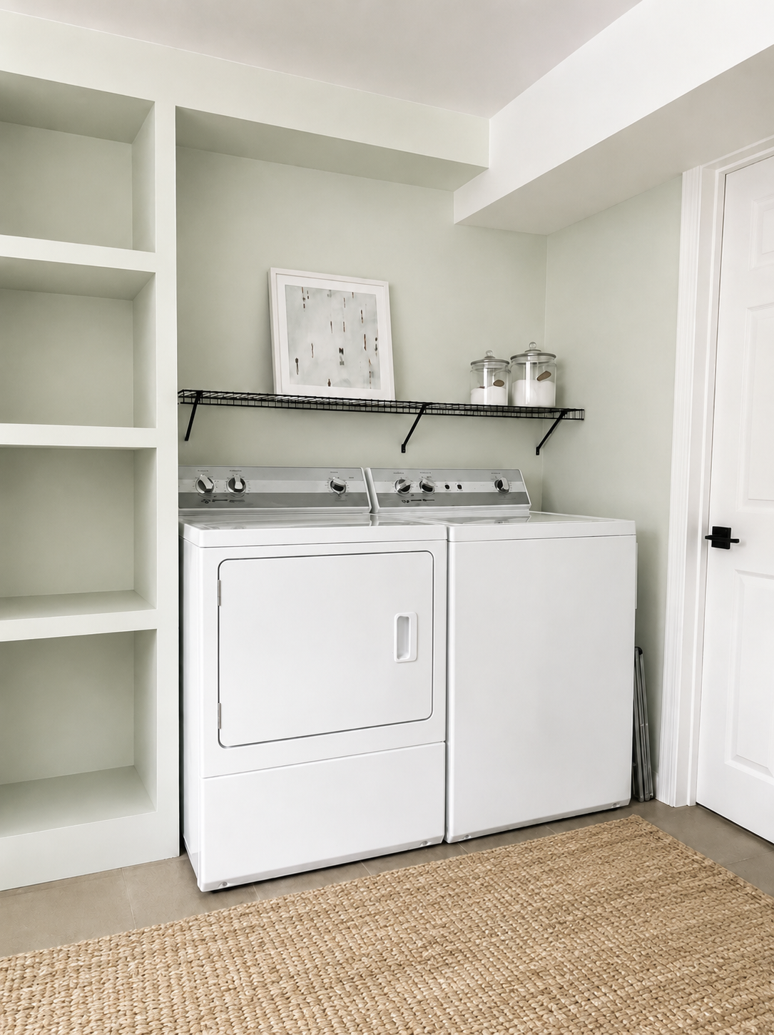 Compact laundry area with open shelving above a white washer and dryer.