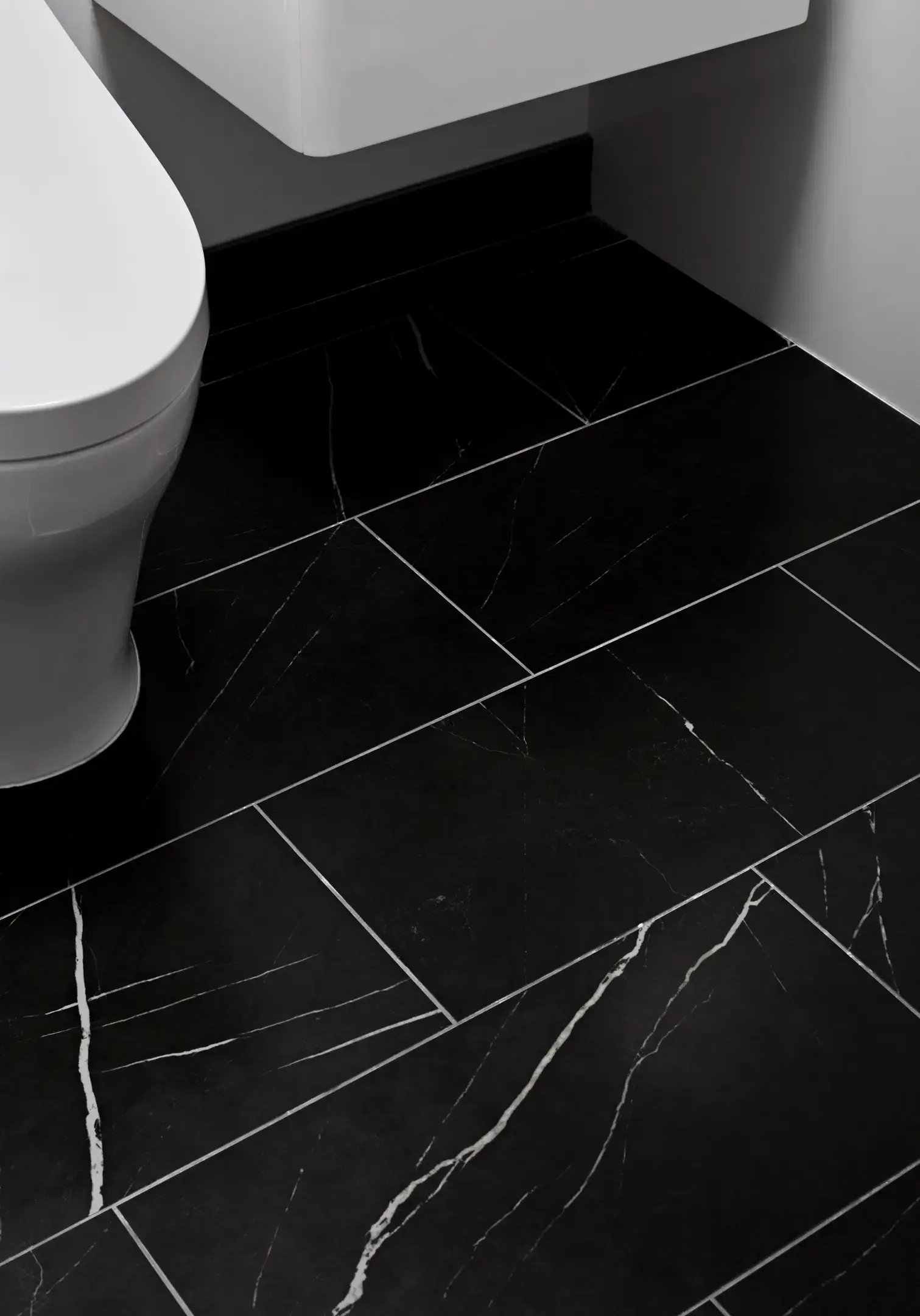 Black floor tiles with white veining