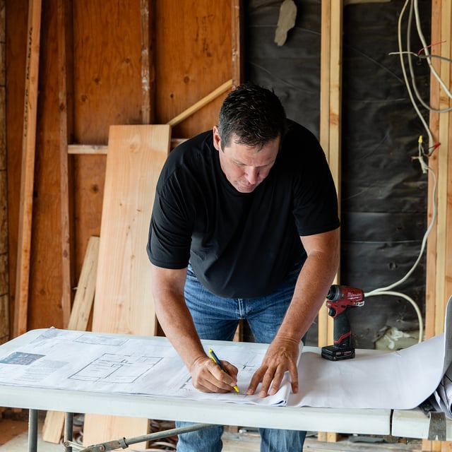 General contractor looking at building remodel plans for a garage renovation