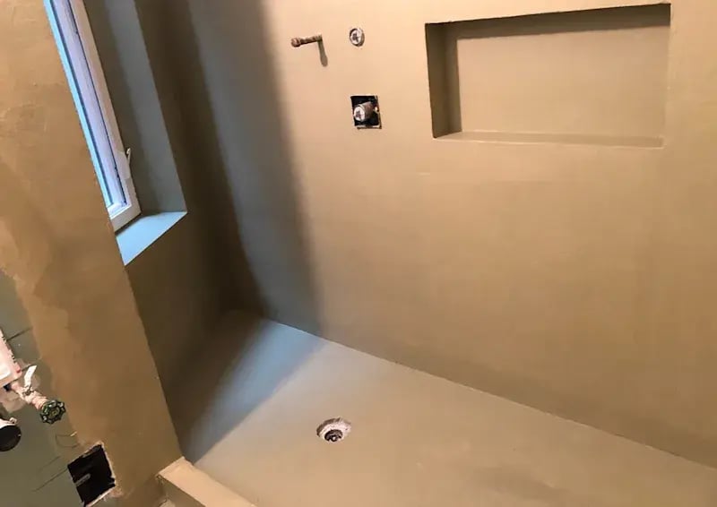 Unfinished shower with waterproofed walls and a niche.
