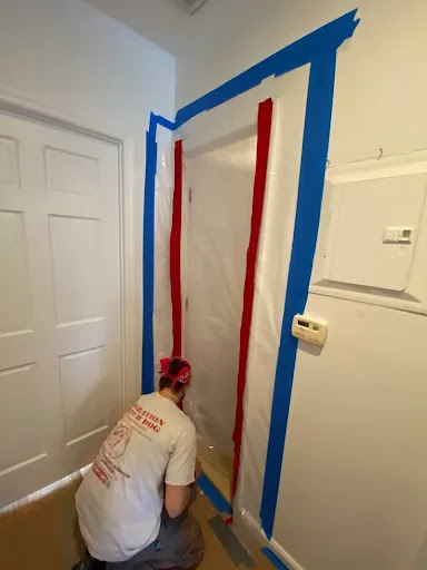 Worker sealing a doorway