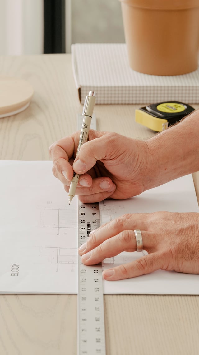 Interior designer working on architectural drawings