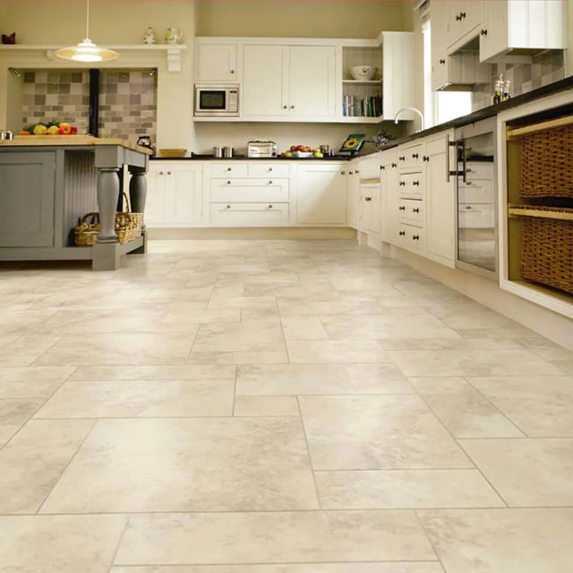  Traditional kitchen with beige tile floors and white cabinets.