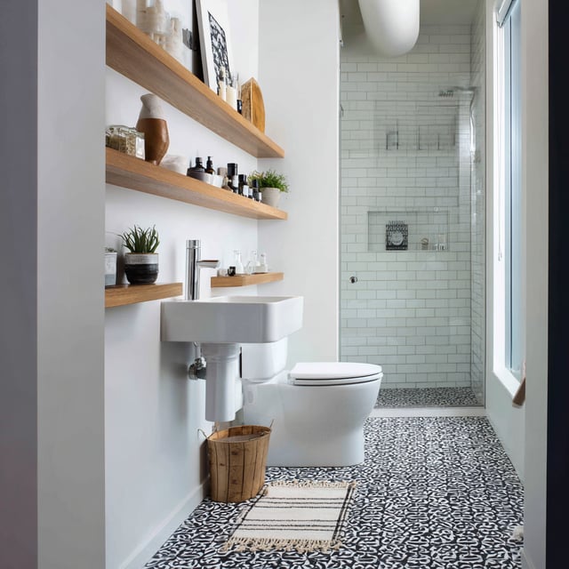 Minimalist bathroom featuring black and white patterned flooring.